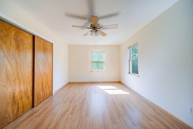 unfurnished bedroom featuring light hardwood / wood-style floors, a closet, and ceiling fan