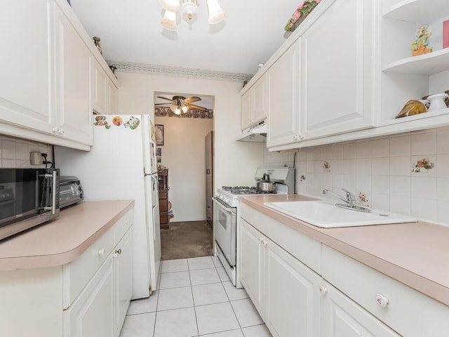 kitchen with white cabinetry, sink, ceiling fan, white appliances, and light tile patterned flooring