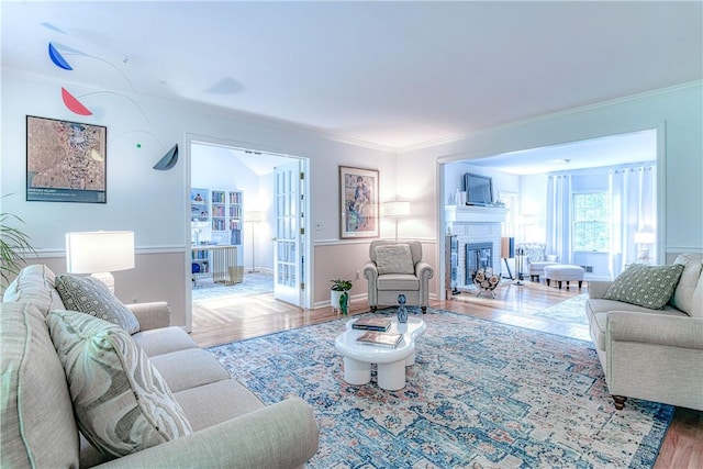 living room featuring crown molding and hardwood / wood-style flooring