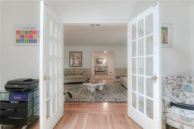 corridor featuring hardwood / wood-style floors and french doors