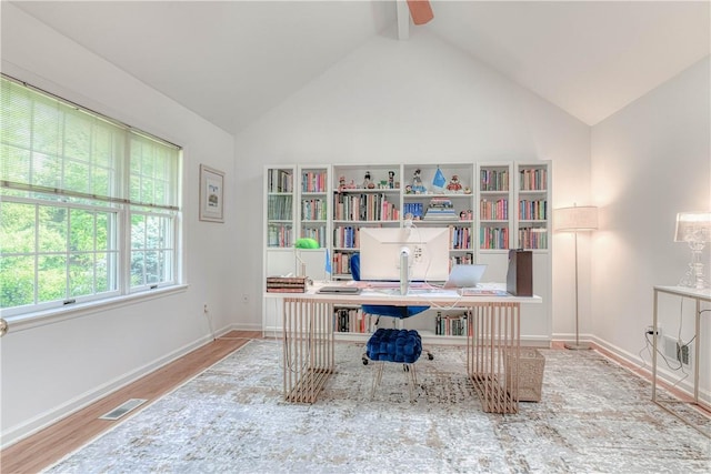 office area with ceiling fan, hardwood / wood-style floors, and lofted ceiling with beams