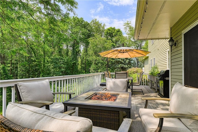 wooden terrace featuring a fire pit and area for grilling