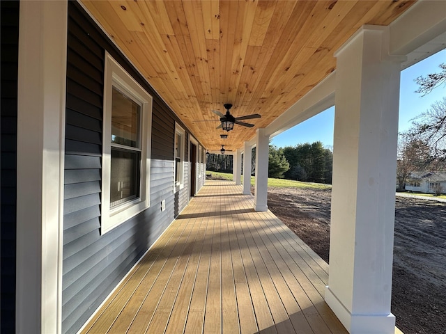 wooden deck featuring a porch and a ceiling fan