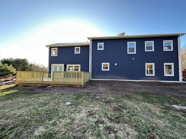 back of house with a yard and a deck