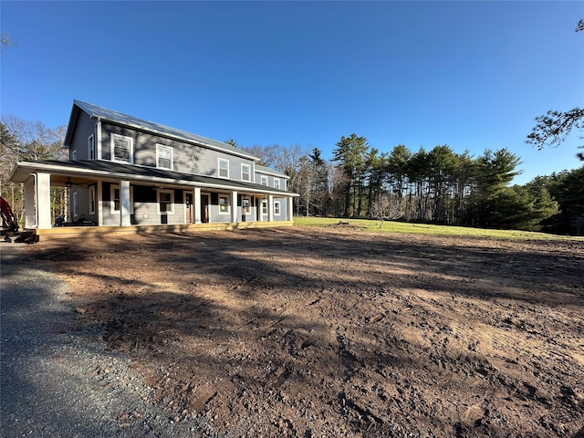 rear view of house with covered porch