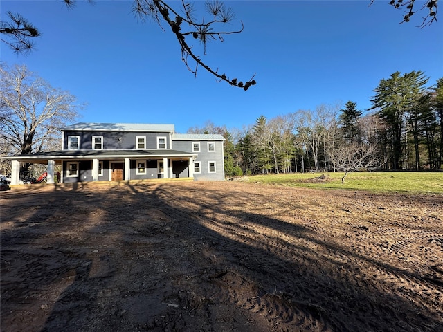 back of property with a porch and a carport
