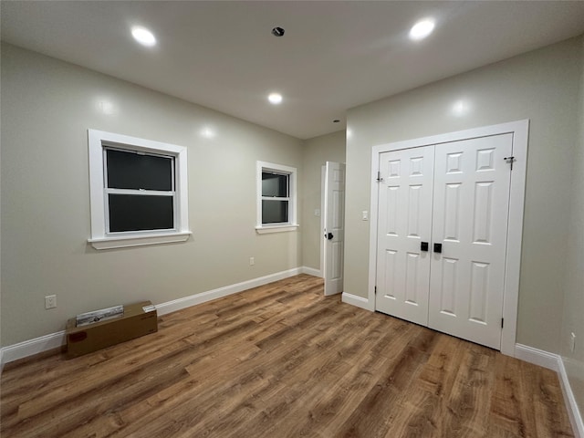 interior space featuring recessed lighting, wood finished floors, and baseboards