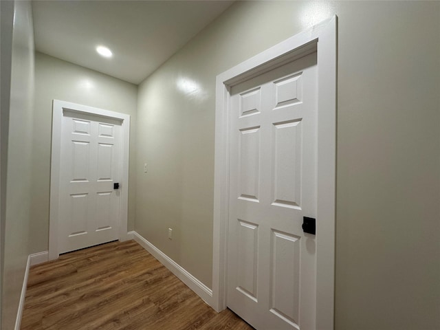 entryway with baseboards, wood finished floors, and recessed lighting