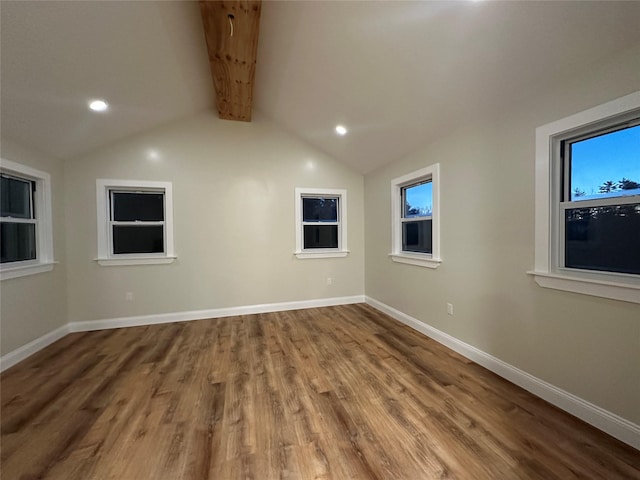 unfurnished room featuring recessed lighting, wood finished floors, baseboards, and lofted ceiling with beams