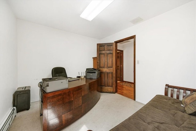 carpeted home office featuring a baseboard heating unit