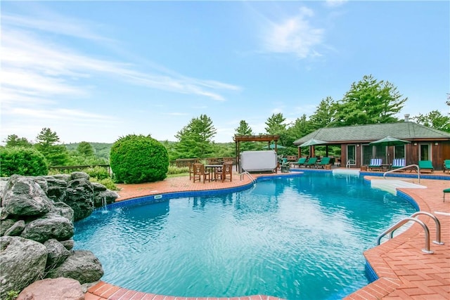 view of swimming pool featuring a patio and pool water feature