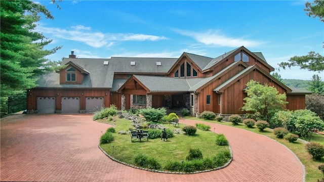 view of front of property with a garage and a front lawn