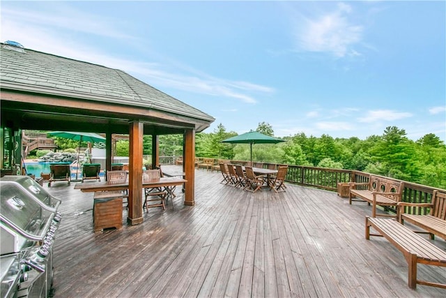 wooden deck with a gazebo and grilling area