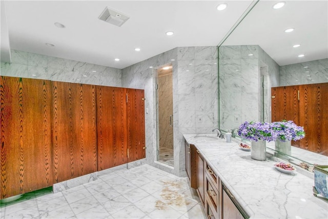 bathroom with vanity, tile walls, and walk in shower