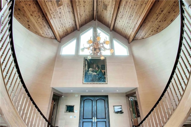 foyer entrance featuring a notable chandelier, beam ceiling, high vaulted ceiling, and wooden ceiling