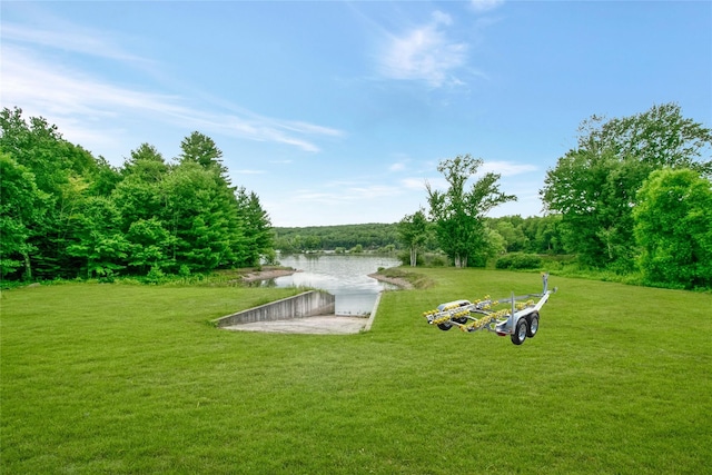 surrounding community with a yard and a water view