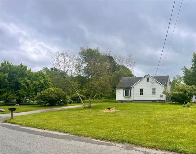 view of property exterior with a lawn