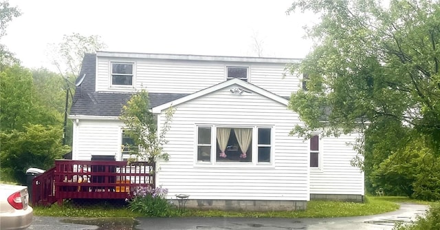 back of property featuring a wooden deck