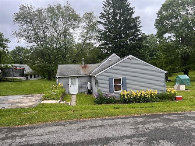 view of front of property with a front yard and a trampoline