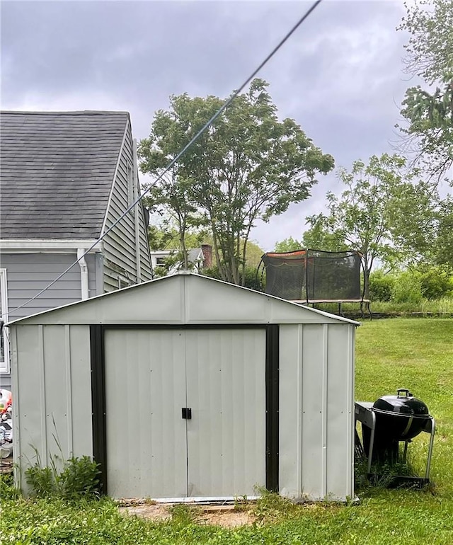 view of outbuilding featuring a lawn