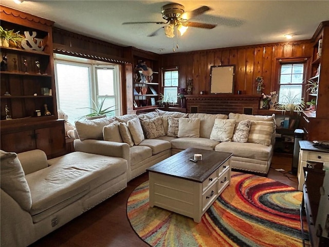 living room with wood walls and ceiling fan