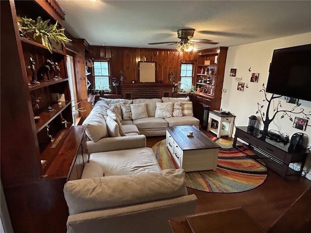 living room featuring ceiling fan and wooden walls