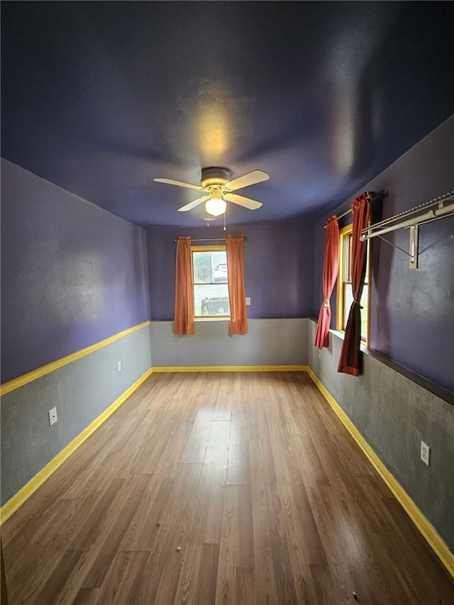 spare room featuring hardwood / wood-style floors and ceiling fan