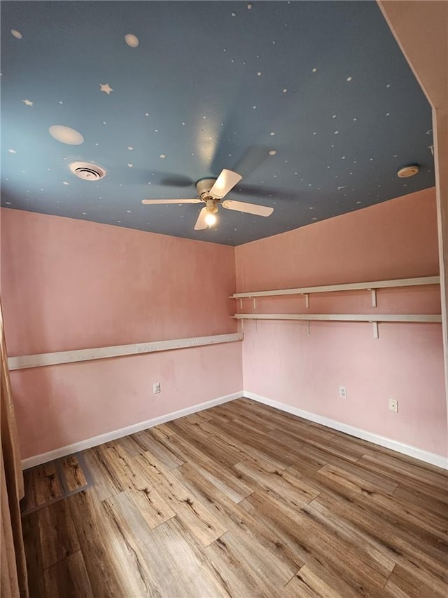 empty room with ceiling fan and wood-type flooring