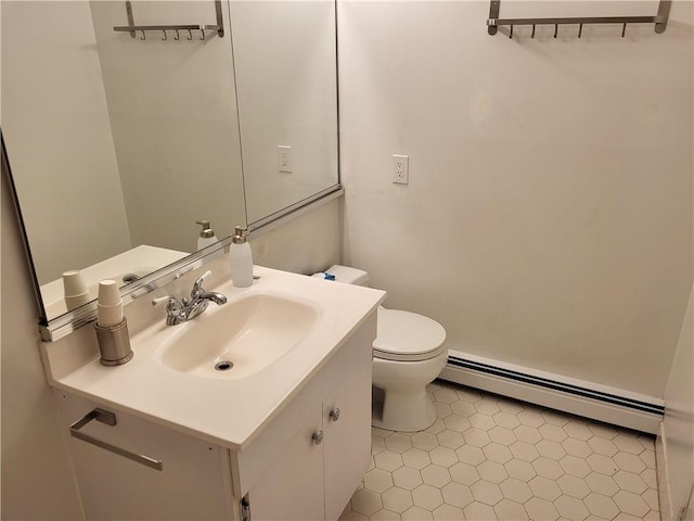 bathroom with vanity, toilet, and baseboard heating