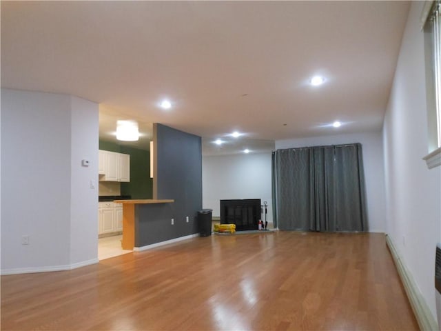 unfurnished living room with light hardwood / wood-style flooring