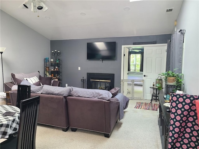 carpeted living room featuring ceiling fan