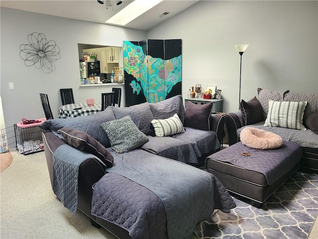 carpeted living room with a skylight