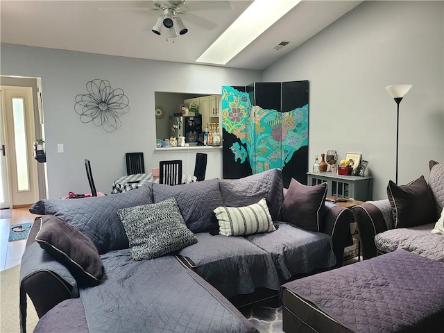 living room featuring a skylight and ceiling fan