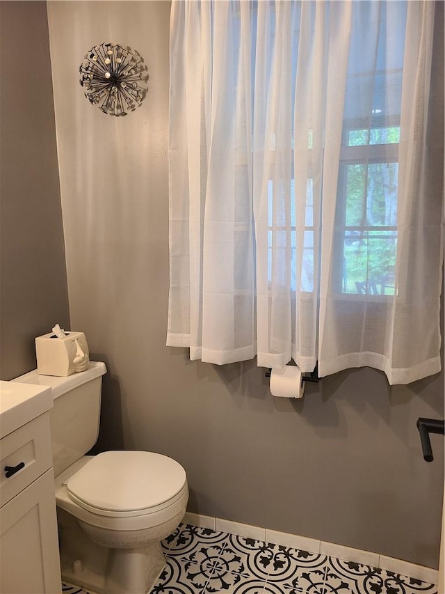 bathroom with tile patterned floors, vanity, and toilet