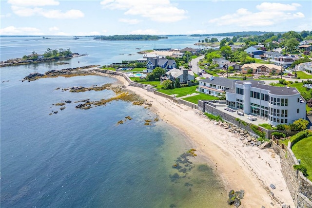 drone / aerial view featuring a beach view and a water view