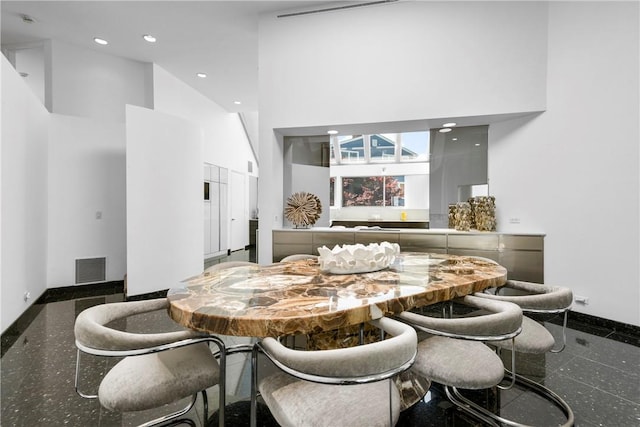 dining area with a high ceiling