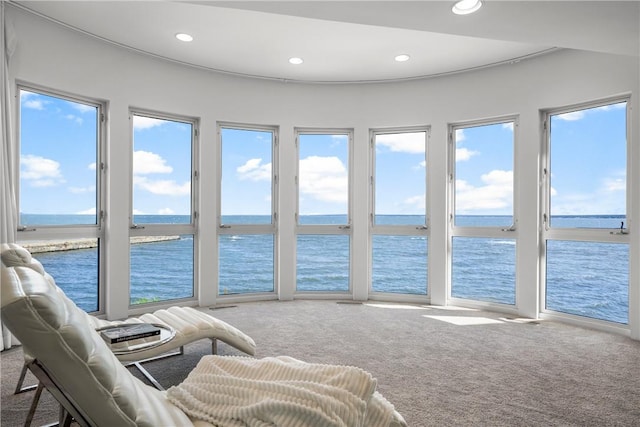 sunroom / solarium featuring a water view