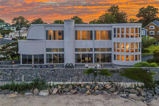 view of back house at dusk