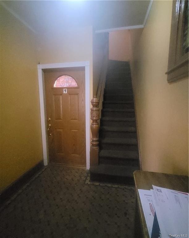 foyer entrance with dark carpet