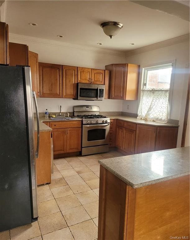 kitchen featuring sink, crown molding, light tile patterned floors, and stainless steel appliances