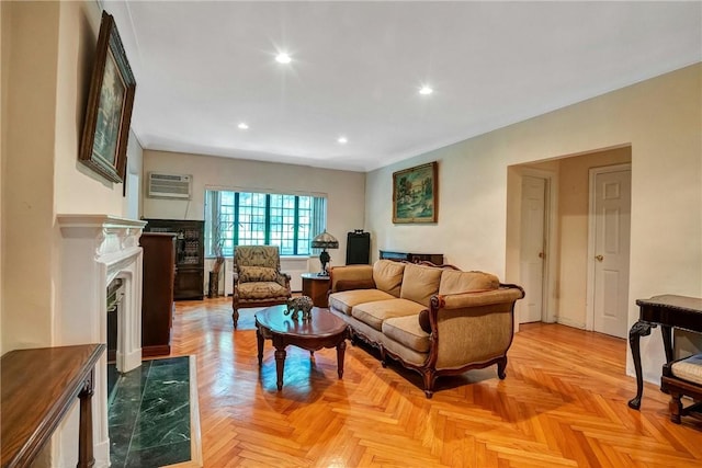 living room with a wall mounted air conditioner and light parquet flooring