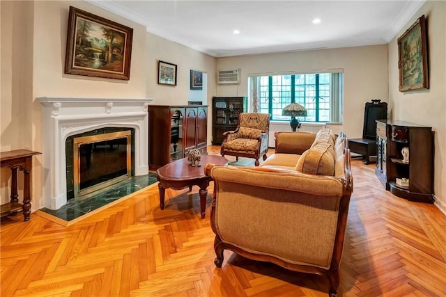 living area featuring crown molding, an AC wall unit, a fireplace, and light parquet flooring