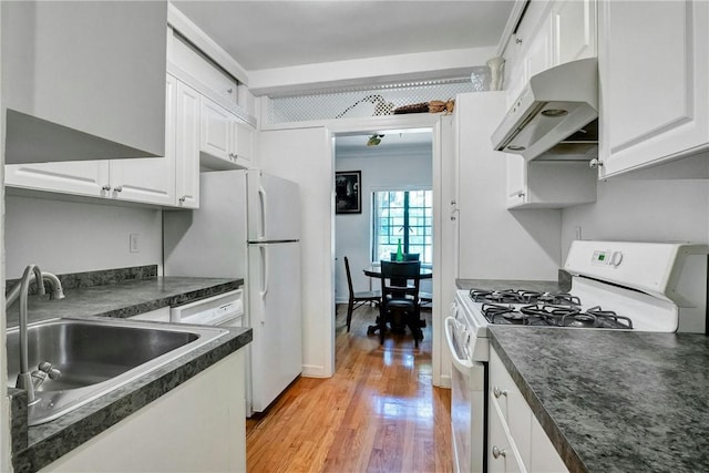 kitchen with white appliances, sink, exhaust hood, light hardwood / wood-style floors, and white cabinetry