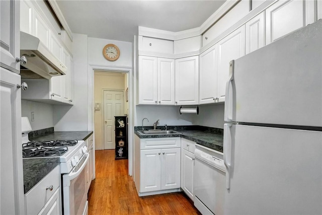 kitchen featuring white cabinetry, sink, wood-type flooring, and white appliances