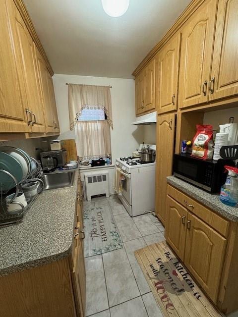 kitchen featuring white range with gas stovetop, radiator heating unit, light tile patterned floors, and sink