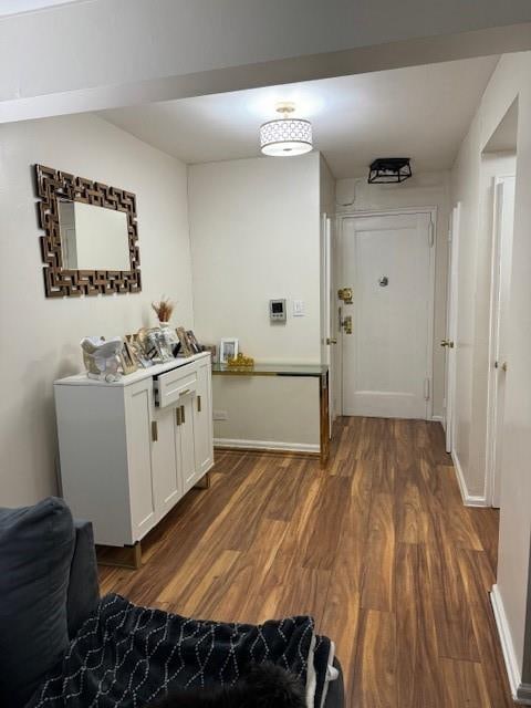 corridor with dark hardwood / wood-style flooring