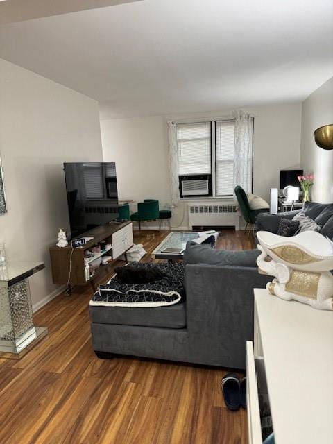 living room featuring radiator heating unit and dark wood-type flooring