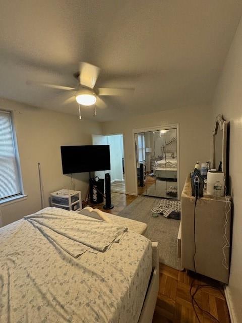 bedroom with parquet floors and ceiling fan