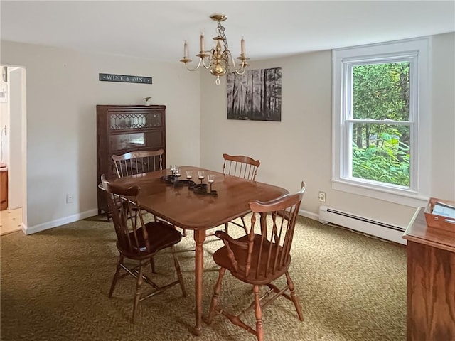 dining space with a chandelier, dark carpet, and baseboard heating