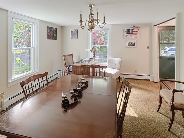 dining area featuring a notable chandelier, light colored carpet, and baseboard heating